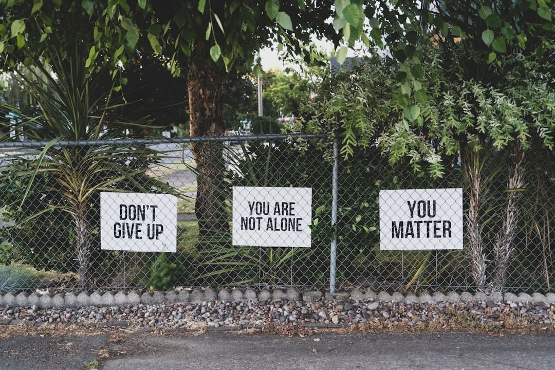 human-animal bond — don't give up. You are not alone, you matter signage on metal fence