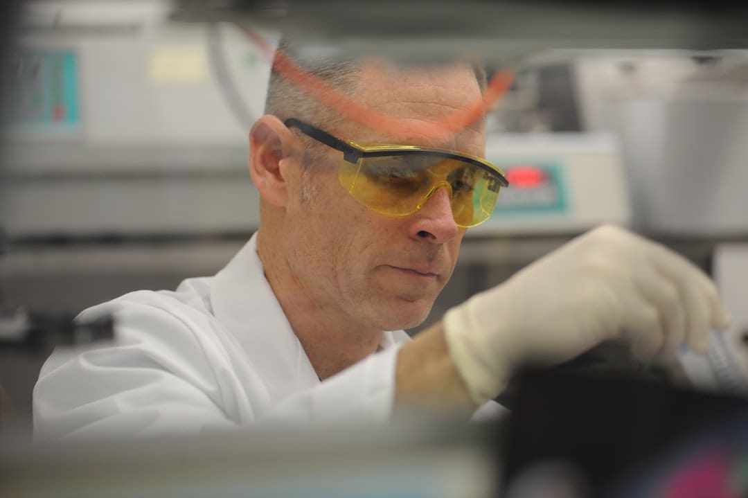 oxytocin brain chemistry — a man in a lab wearing safety goggles